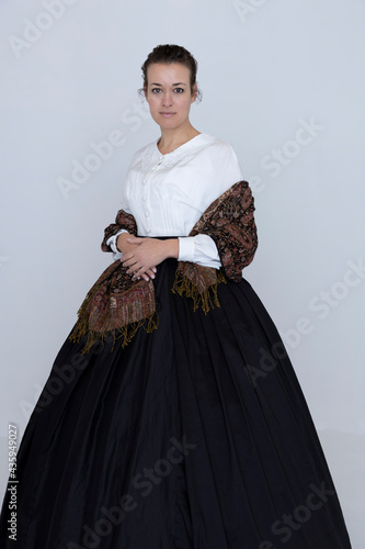 Canvas Print A Victorian woman wearing a white Garibaldi blouse and black skirt  with a paisl