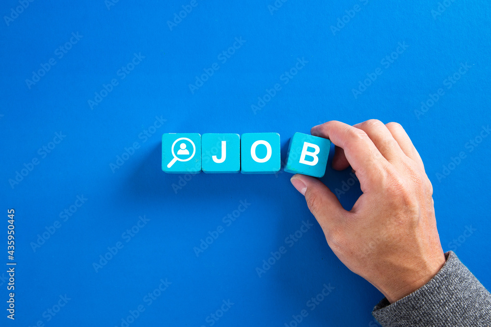 The word job on wooden cubes with on blue background. Searching for a job, employment, recruitment or career concept. The word job on wooden cubes with on blue background. Searching for a job, employment, recruitment or career concept.