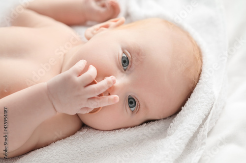 Cute little baby lying on b...