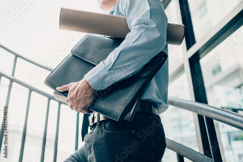 Konstfotografi Busy businessman hold dossier and drawing tube