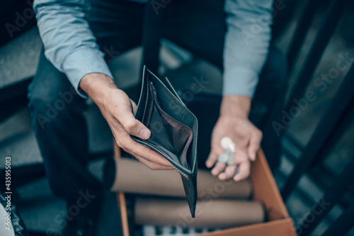 фотографія Office worker lost his job and open a wallet without money