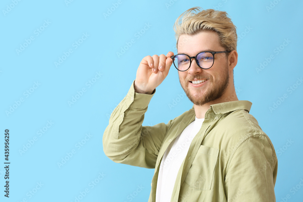Young man wearing eyeglasses on color background Young man wearing eyeglasses on color background