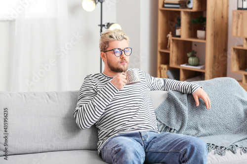 Young man relaxing on sofa ...