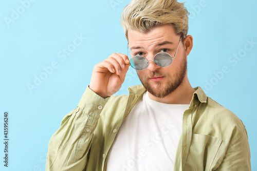 Young man with stylish sung...
