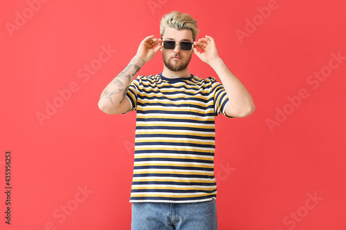 Young man with stylish sung...