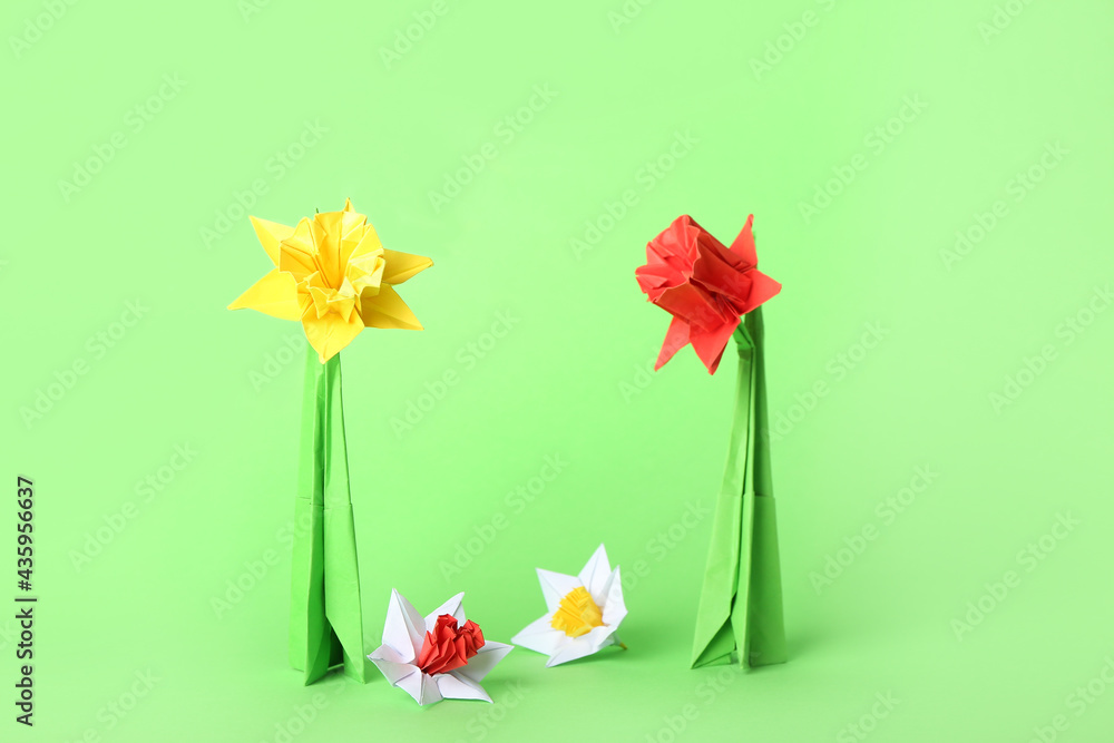 Origami daffodils on color background