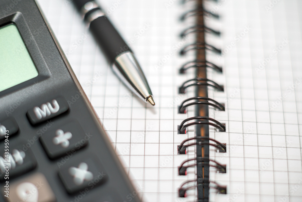Calculator and pen on notebook. Business plan analysis concept. Business concept.Closeup. Calculator and pen on notebook. Business plan analysis concept. Business concept.Closeup.