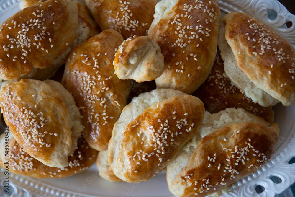 homemade pastry with sesame seeds and cheese inside from traditional Turkish cuisine. Front view. homemade pastry with sesame seeds and cheese inside from traditional Turkish cuisine. Front view.