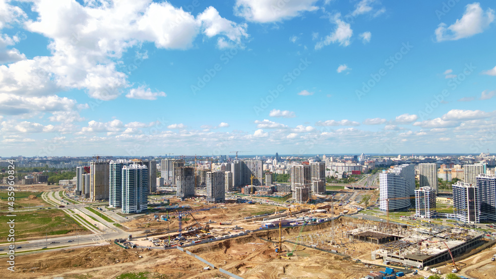 Modern urban development. Construction site with multi-storey buildings under construction. Construction work is underway. Aerial photography.