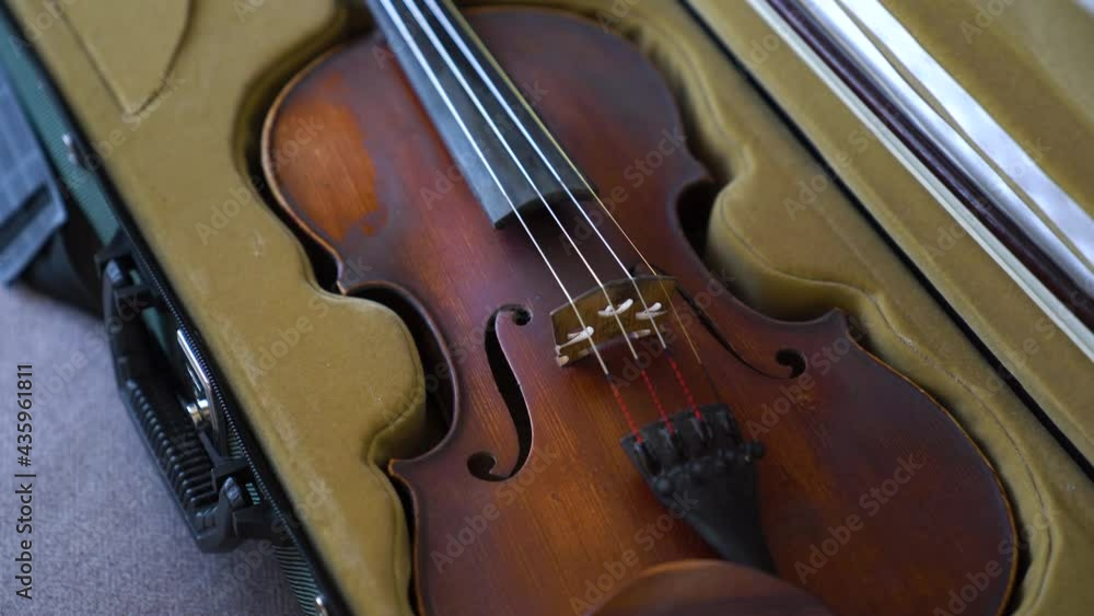 Close-up of female taking the violin out of its case Close-up of female taking the violin out of its case