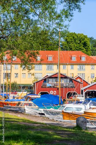 Boats and houses in harbor in Hjo, Sweden