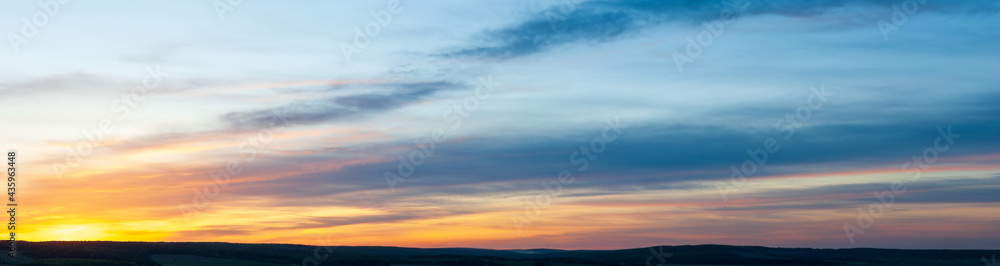 Panoramic view on evening sky with colorful sunlight, summer horizontal banner