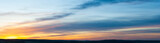 Panoramic view on evening sky with colorful sunlight, summer horizontal banner