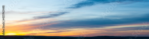 Panoramic view on evening sky with colorful sunlight, summer horizontal banner © Natalya
