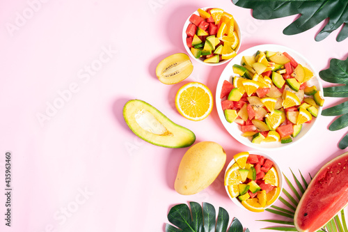 Chopped tropical fruit in bowls and plates