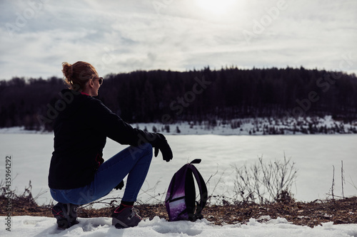 Woman enjoying on a mountain winter fresh air. photo