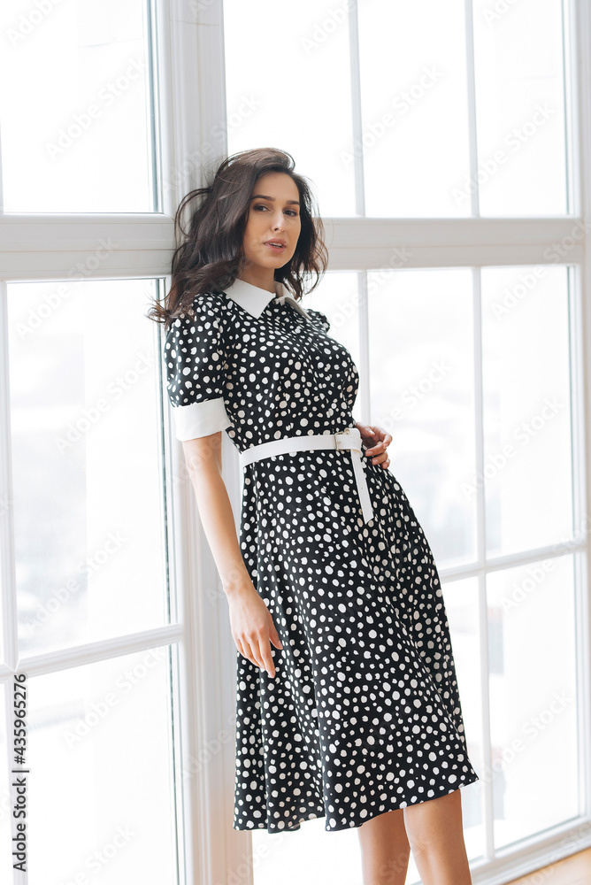 adult young woman is resting in a beautiful feminine blue dress in a bright room by the window relax rest break anticipation anticipation date adult young woman is resting in a beautiful feminine blue dress in a bright room by the window relax rest break anticipation anticipation date