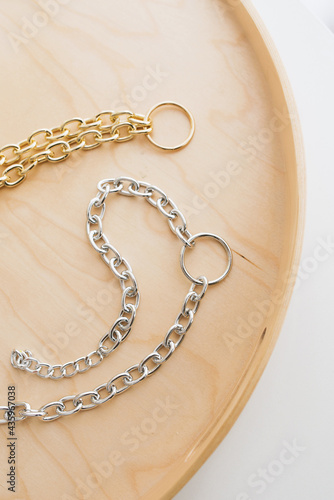 jewelry bijouterie gold silver chains handmade hobby lies on the table by the window on a wooden tray necklace necklace