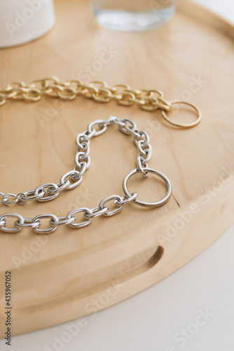jewelry bijouterie gold silver chains handmade hobby lies on the table by the window on a wooden tray necklace necklace