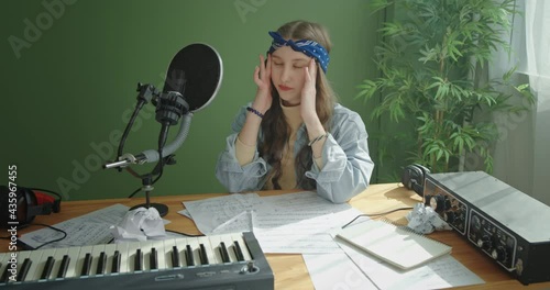 Upset songwriter crumpling and throwing paper away