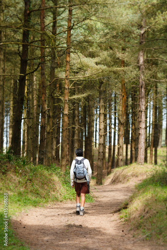 Indian Asian woman hiking in Gower Peninsula, Wales, UK