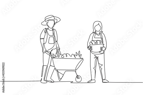 Single continuous line drawing happy couple farmer with wheelbarow trolley and basket full of fruits. A successful harvest activity minimalism concept. One line draw graphic design vector illustration