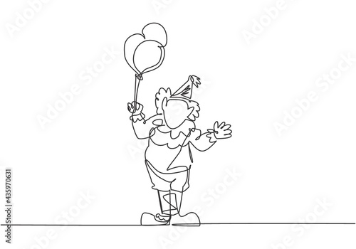 Single continuous line drawing the male clown stands while holding several balloons in his right hand. Children really like the show. Dynamic one line draw graphic design vector illustration.