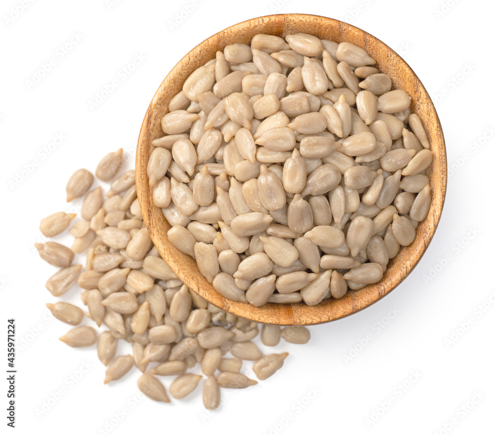 peeled sunflower seeds in the wooden bowl, isolated on whtie background, top view peeled sunflower seeds in the wooden bowl, isolated on whtie background, top view