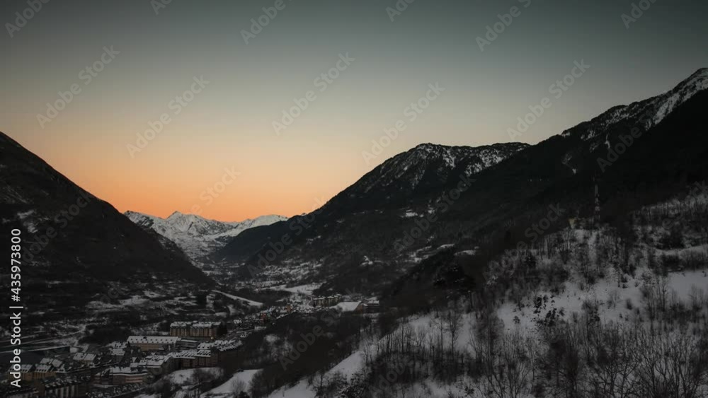 TIME LAPSE - Town in a valley in the Pyrenees, day to night, wide shot zoom in TIME LAPSE - Town in a valley in the Pyrenees, day to night, wide shot zoom in