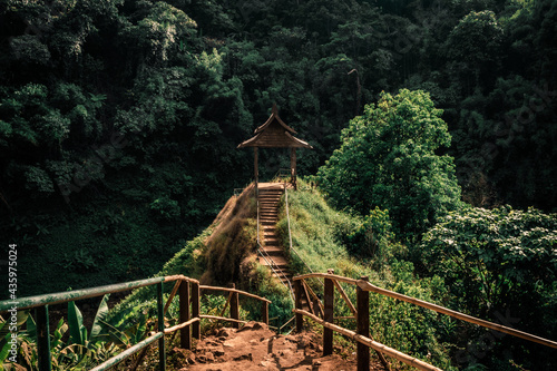 Road to the beautiful wooden Viewpoint in the fresh green forest in Indochina. Tad Yuang waterfall, Pakse, Bolaven Plateu, Laos photo