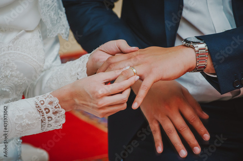 Newly wed couple's hands with wedding rings