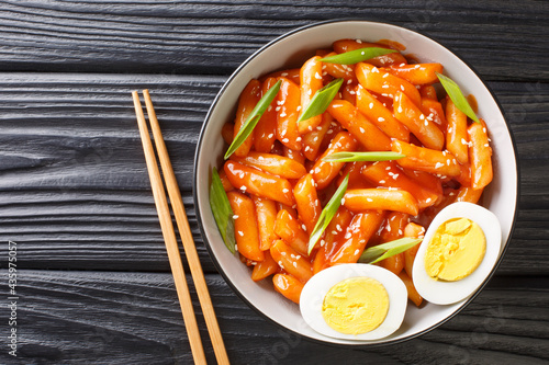 Hot and spicy rice cake Tteokbokki recipe close-up in a bowl on the table. horizontal top view from above photo