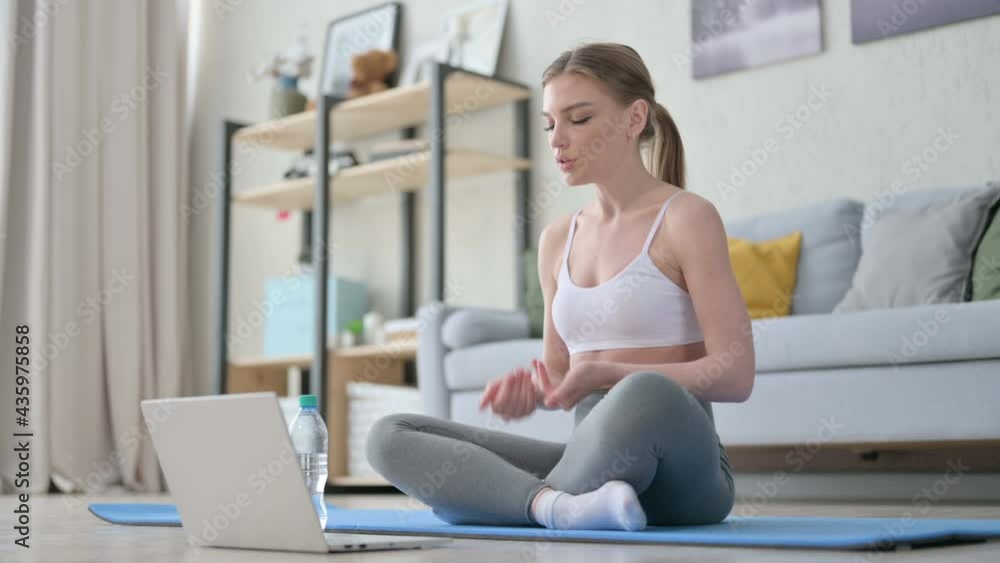 Woman doing Video Call on Laptop while on Yoga Mat Woman doing Video Call on Laptop while on Yoga Mat