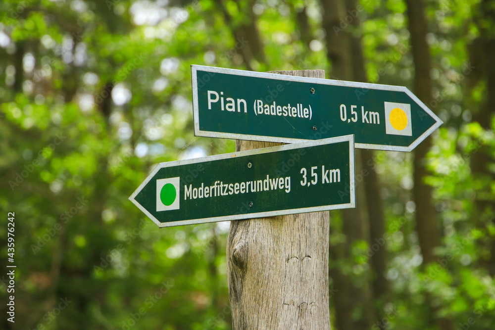 Guide post to circular hiking trail Moderfitz lake (Moderfitzsee)and hiking trail to Pian beach, Germany Guide post to circular hiking trail Moderfitz lake (Moderfitzsee)and hiking trail to Pian beach, Germany