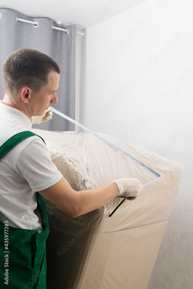 the delivery department takes measurements before sending the goods, side view the delivery department takes measurements before sending the goods, side view