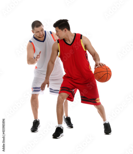 Professional sportsmen playing basketball on white background
