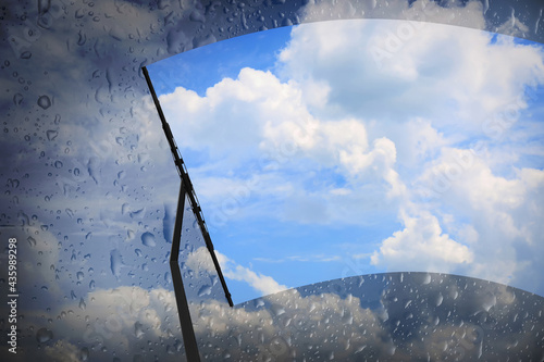 Photos Car windshield wiper cleaning water drops from glass