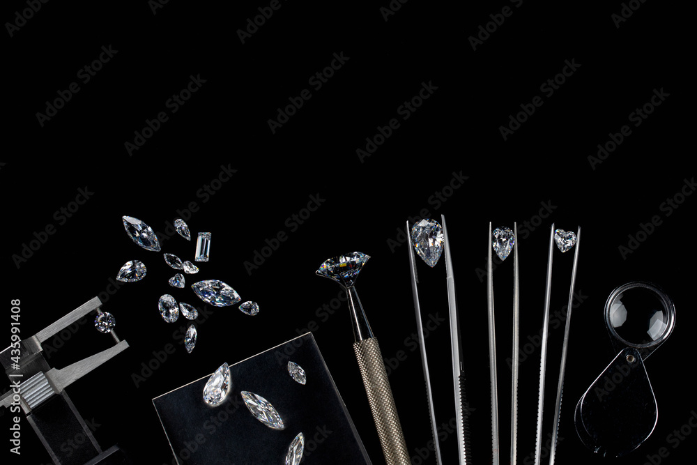 Diamonds of different sizes at the workplace of diamond dealer evaluating polished diamonds. High quality photo - obrazy, fototapety, plakaty 