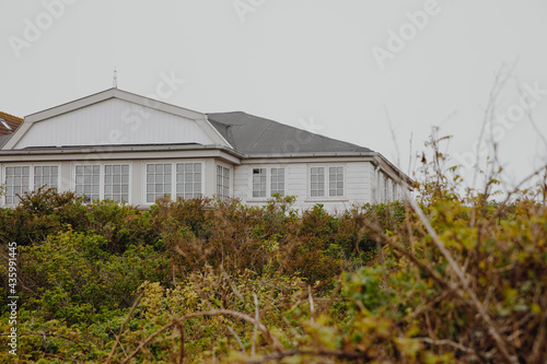 Fototapeta Naklejka Na Ścianę i Meble -  White house between the dunes on an island. House by the sea 