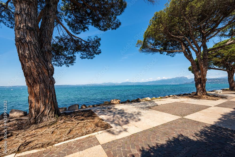 Lago di Garda. The Lake Garda view from the small town of Lazise, tourist resort on the coast, Verona province, Veneto, Italy, southern Europe. In the background the coast of Lombardy.