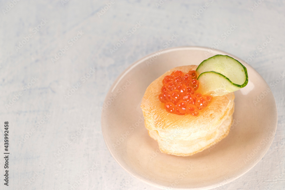 top view of appetizer with red caviar. Tartlets, red caviar, cucumber on a white background with space for your text. Delicious and healthy snack. top view of appetizer with red caviar. Tartlets, red caviar, cucumber on a white background with space for your text. Delicious and healthy snack.