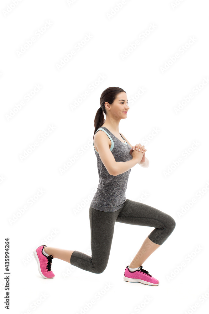 Young fitness woman workout lunging Young fitness woman workout lunging