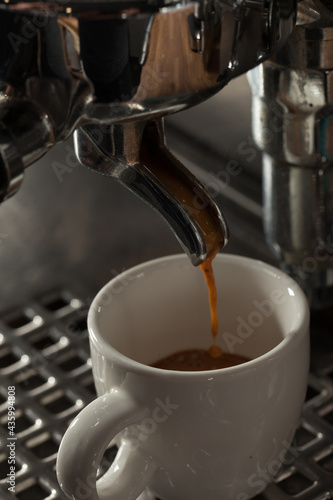 Close-up of espresso preparing in coffee machine, selective focus