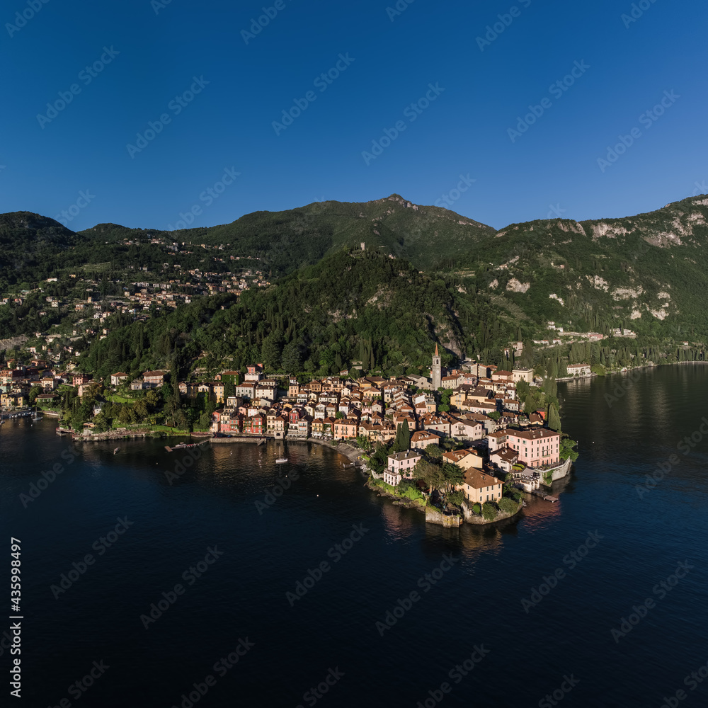 Varenna village on Lake Como square aerial picture with the bell tower of the city, Vezio Castel and the lakeside walk.