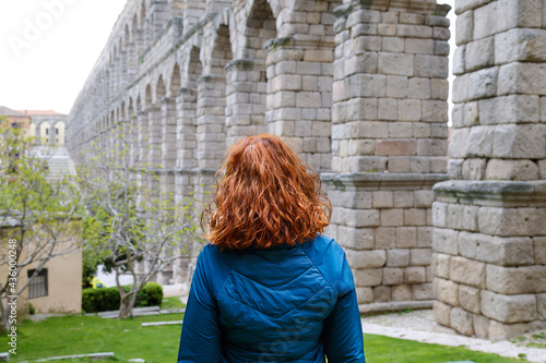 Woman enjoying the view of the Roman Aqueduct in Segovia, Spain photo