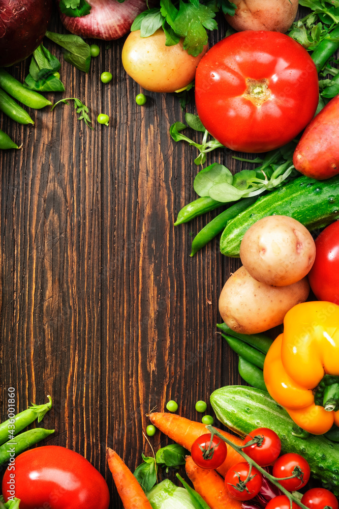 Healthy food. Assortment of fresh summer organic vegetables and herbs on wooden table background Healthy food. Assortment of fresh summer organic vegetables and herbs on wooden table background