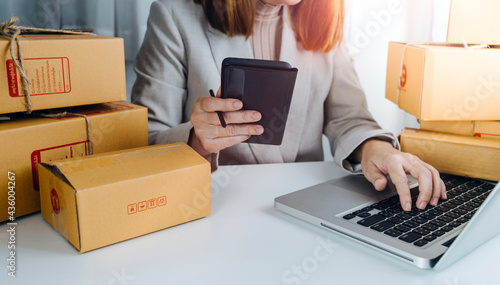 Business woman start up small business entrepreneur SME success .freelance woman working at home with Online Parcel delivery. SME and packaging deliveryconcept © ARMMY PICCA