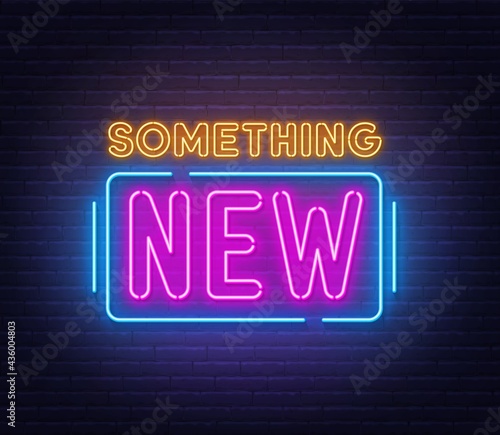 Something new neon sign on brick wall background.