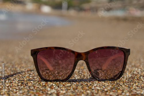 sunglasses in the sand by the sea