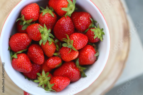 Bowl of fresh strawberries on a table. Top view.